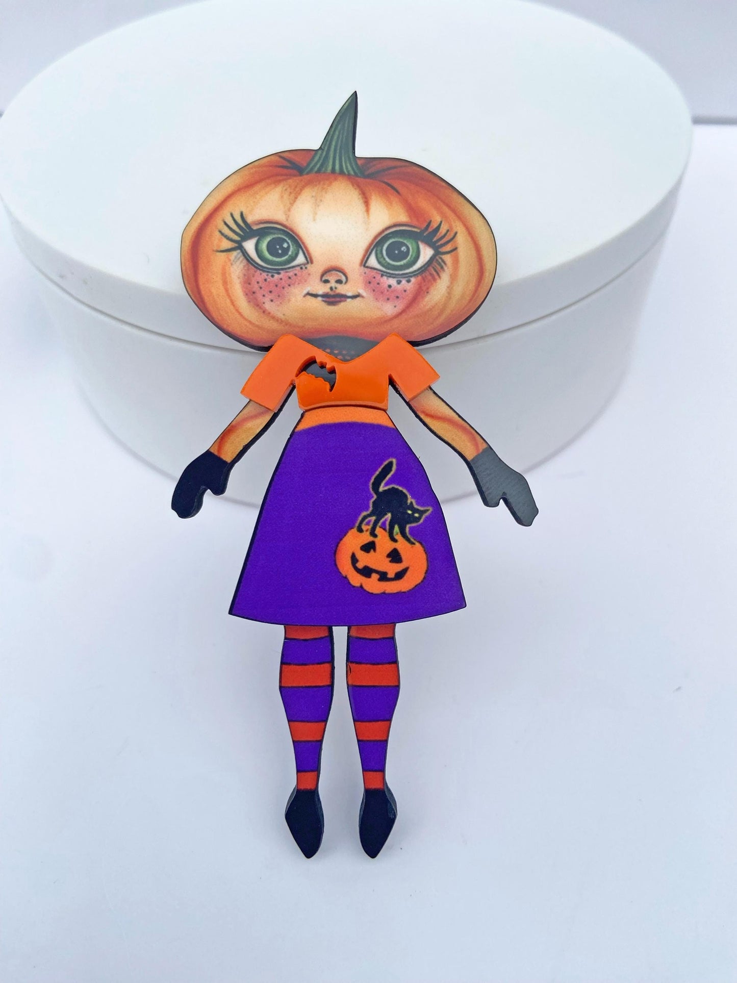 Pumpkin Girl Fall Halloween Brooch ~ Whimsical Autumn Design. Her outfit is adorned with a pumpkin, a black cat, and a bat. Handmade
