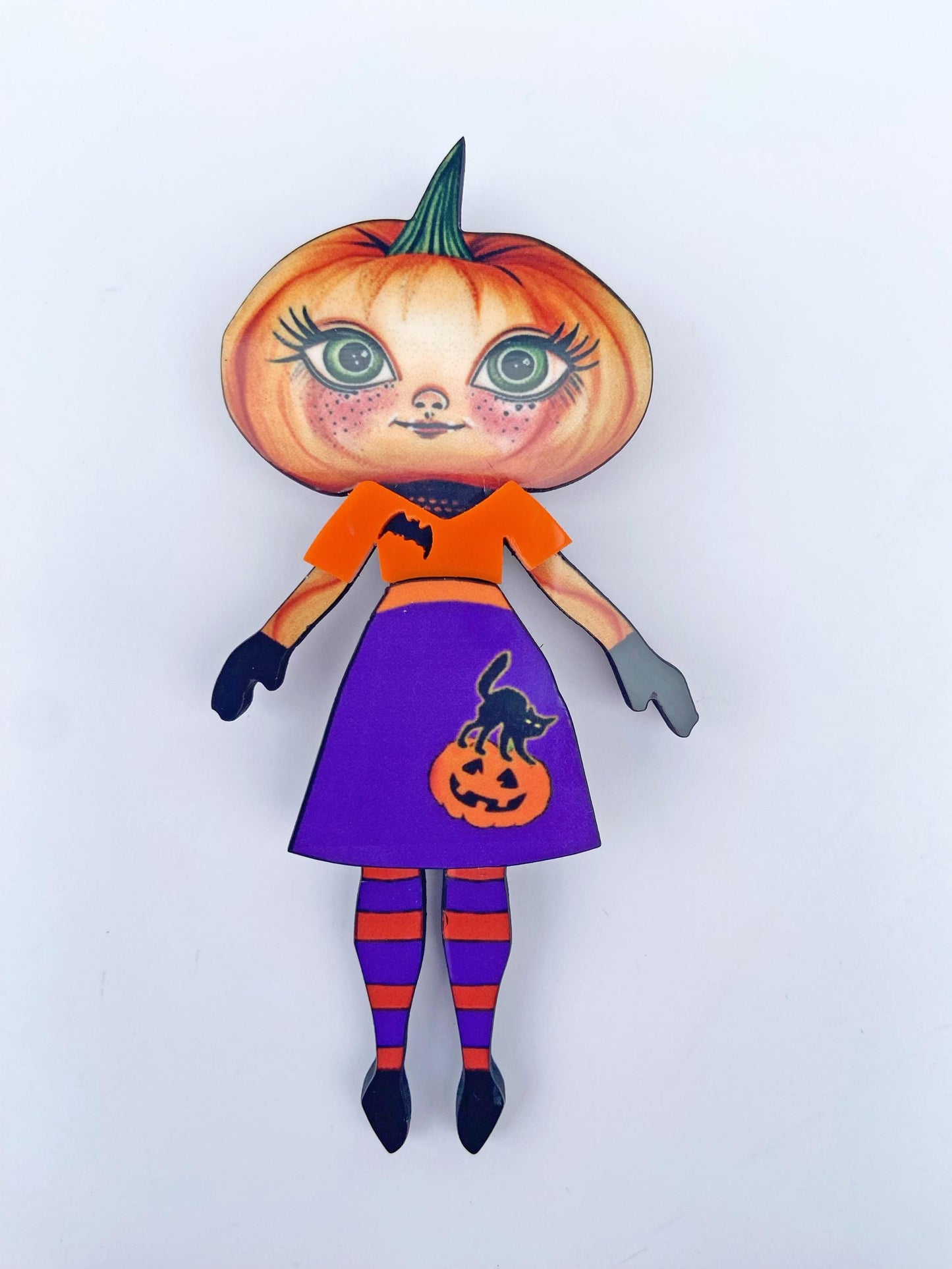 Pumpkin Girl Fall Halloween Brooch ~ Whimsical Autumn Design. Her outfit is adorned with a pumpkin, a black cat, and a bat. Handmade