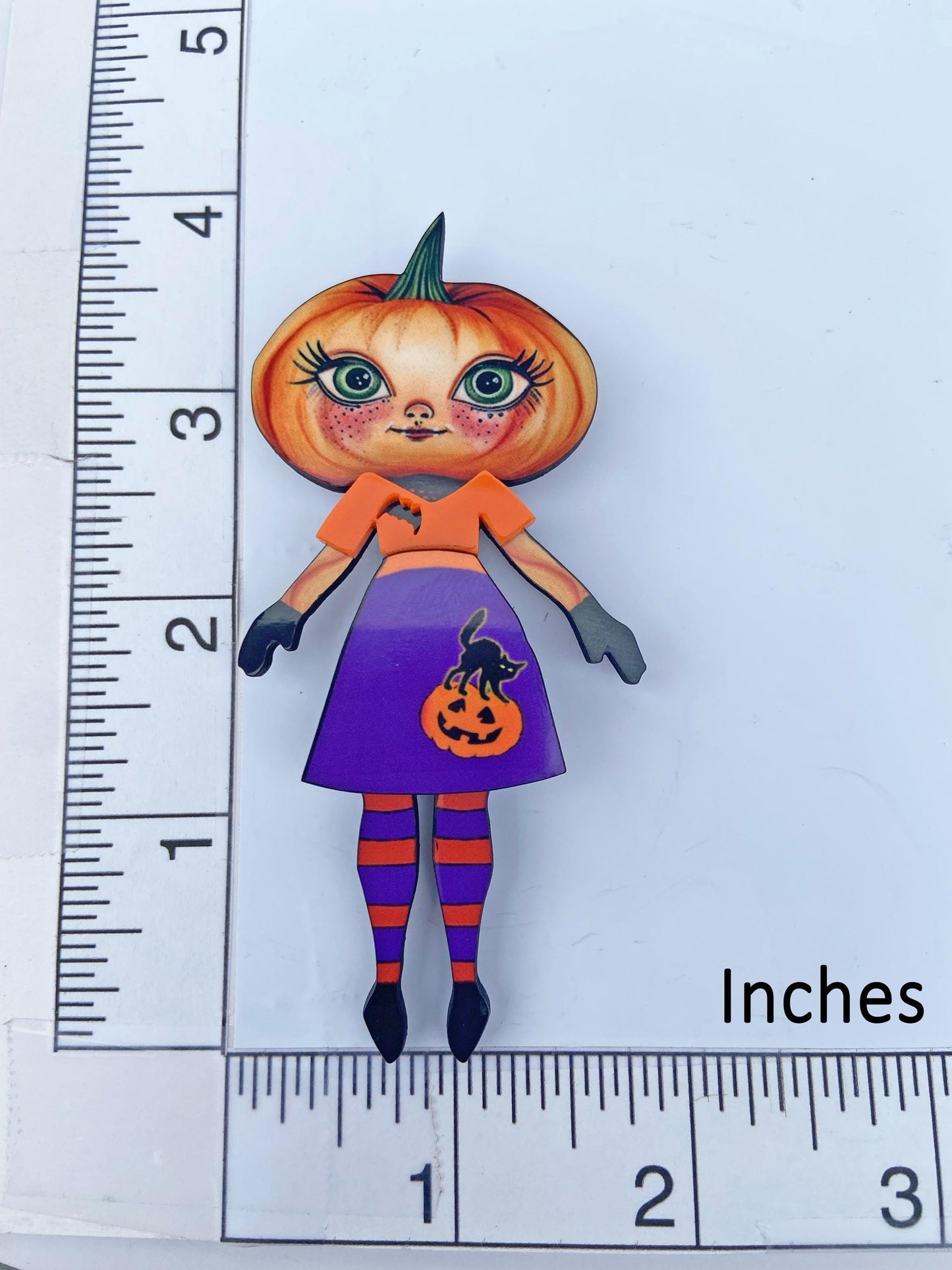 Pumpkin Girl Fall Halloween Brooch ~ Whimsical Autumn Design. Her outfit is adorned with a pumpkin, a black cat, and a bat. Handmade