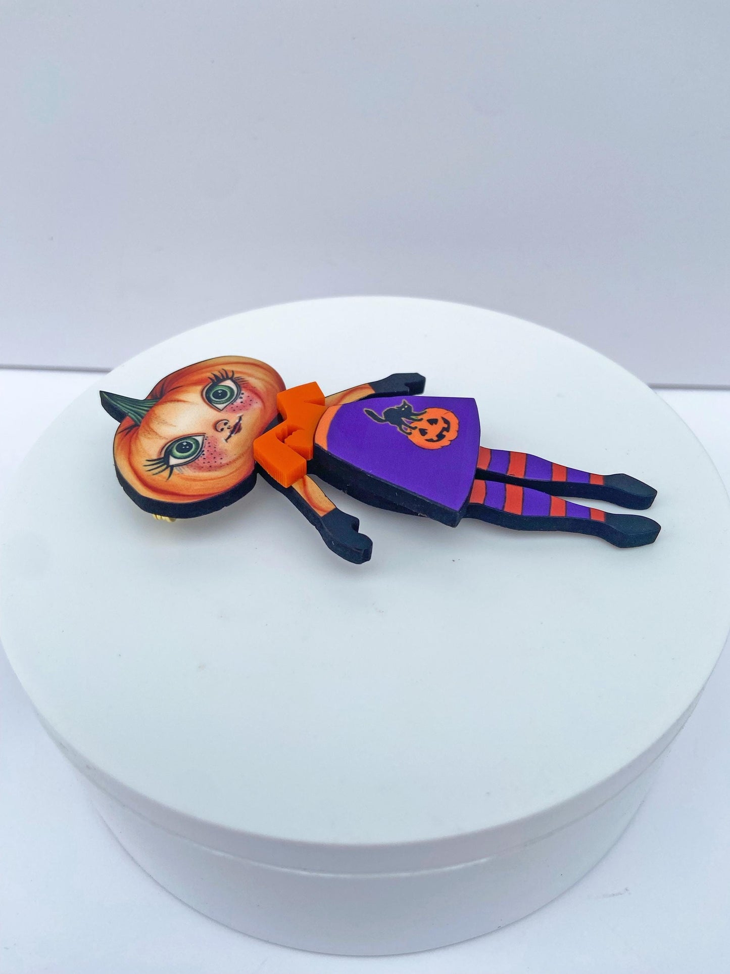 Pumpkin Girl Fall Halloween Brooch ~ Whimsical Autumn Design.  Her outfit is adorned with a pumpkin, a black cat, and a bat.  Handmade